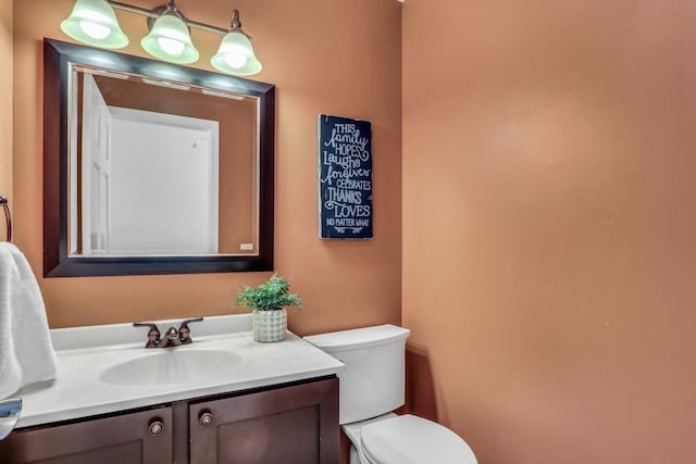half bathroom with toilet and vanity