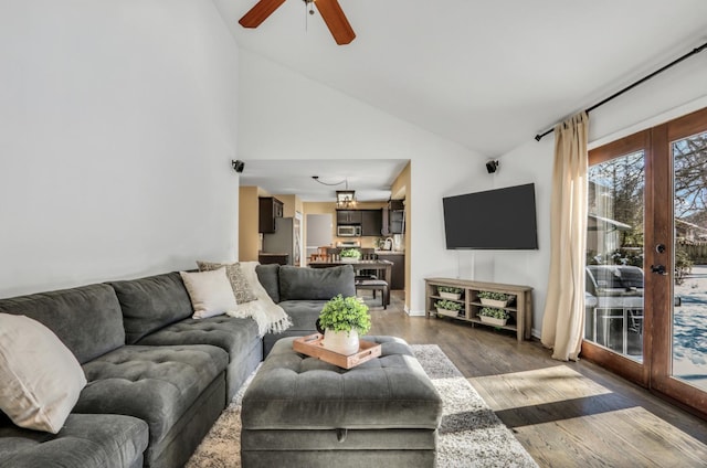 living room with french doors, wood finished floors, high vaulted ceiling, and ceiling fan