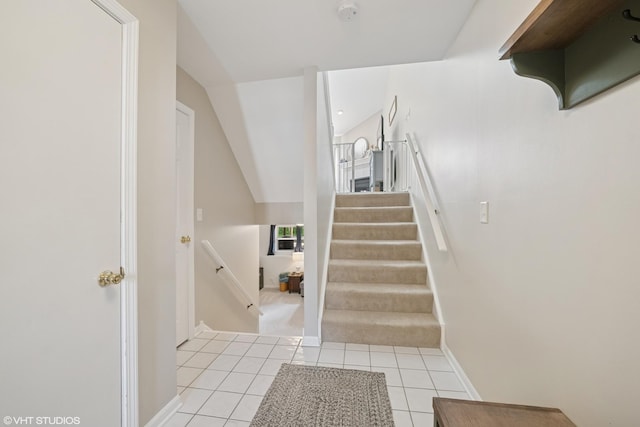 stairway featuring tile patterned floors and baseboards