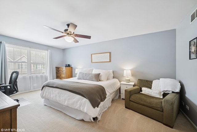 bedroom featuring visible vents, baseboards, ceiling fan, and light carpet