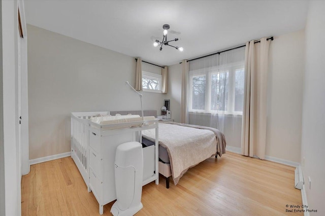 bedroom with light wood-style floors and baseboards