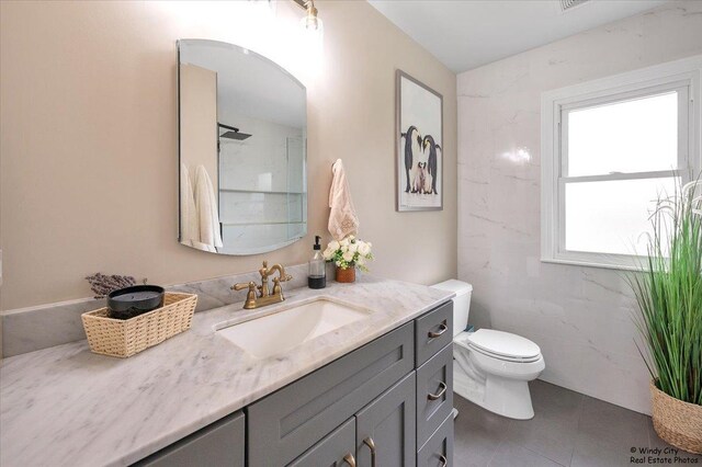 bathroom with tile patterned floors, vanity, and toilet
