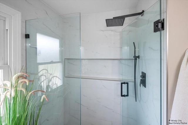 full bathroom featuring a marble finish shower
