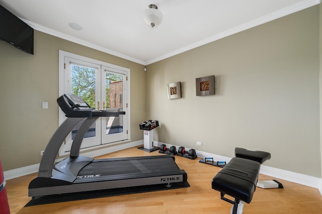 workout area with ornamental molding, french doors, baseboards, and wood finished floors
