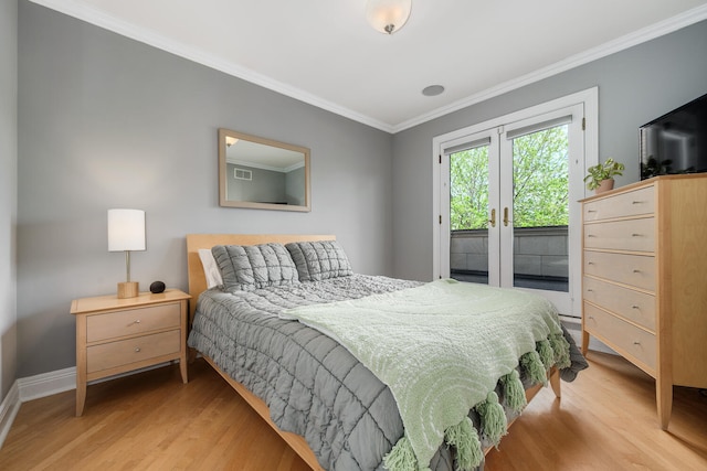 bedroom with access to exterior, light wood-style flooring, ornamental molding, baseboards, and french doors