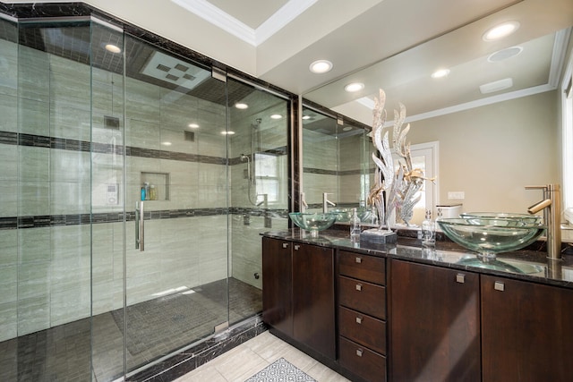 bathroom featuring ornamental molding, a stall shower, double vanity, tile patterned floors, and recessed lighting