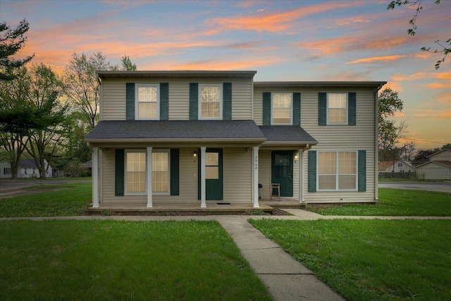 traditional home with a porch and a front yard