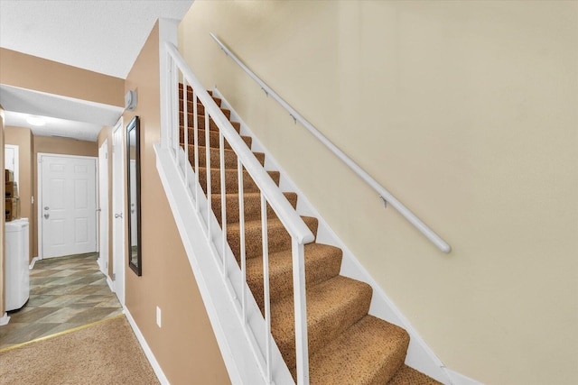stairway with carpet and baseboards