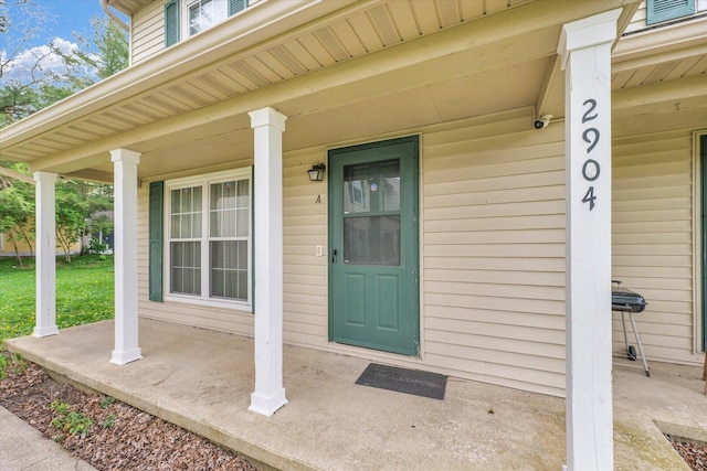 view of exterior entry with a porch