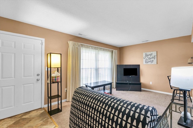 living area with visible vents, carpet flooring, and baseboards