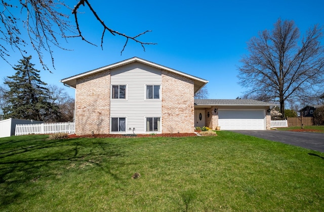 2532 Lee St, Woodridge, IL 60517 - exterior space with an attached garage, brick siding, fence, and driveway