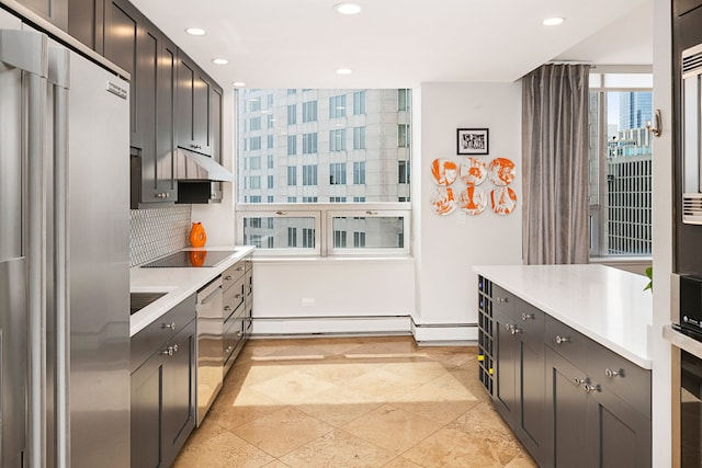 kitchen featuring tasteful backsplash, light countertops, baseboards, appliances with stainless steel finishes, and recessed lighting