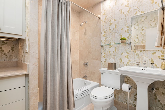 full bath with shower / tub combo, toilet, a sink, and tile walls