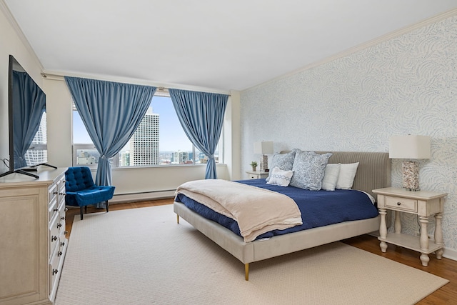 bedroom featuring multiple windows, wallpapered walls, wood finished floors, and crown molding