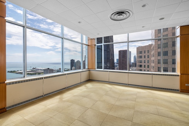 empty room with a view of city, a wealth of natural light, and a water view