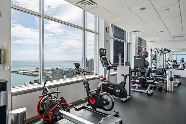 workout area featuring visible vents and a water view