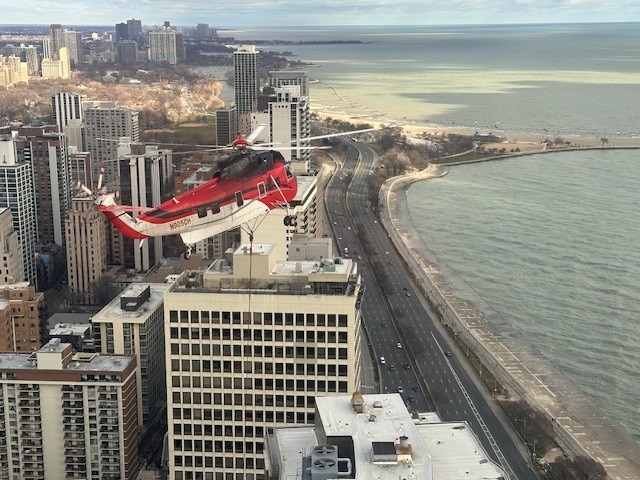 birds eye view of property featuring a city view and a water view