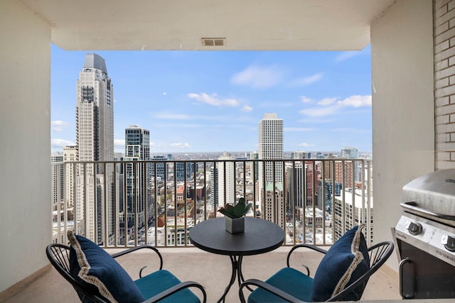 balcony with a city view, a grill, and visible vents
