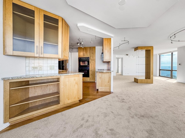 kitchen with rail lighting, open floor plan, dark carpet, and decorative backsplash