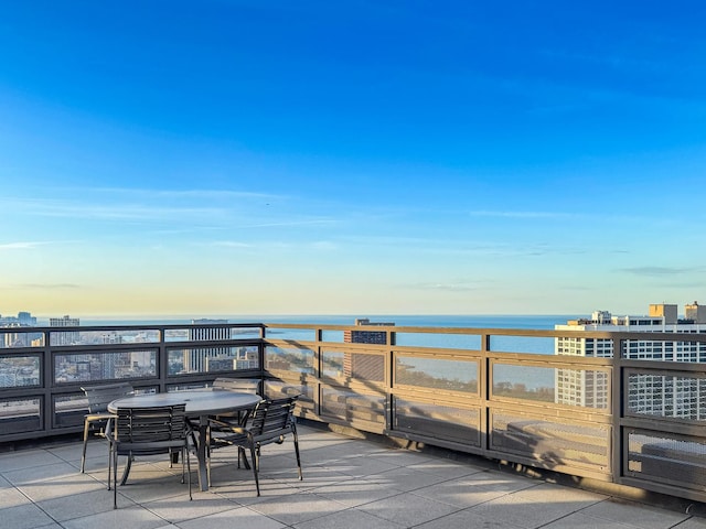 view of patio / terrace featuring a water view and outdoor dining space