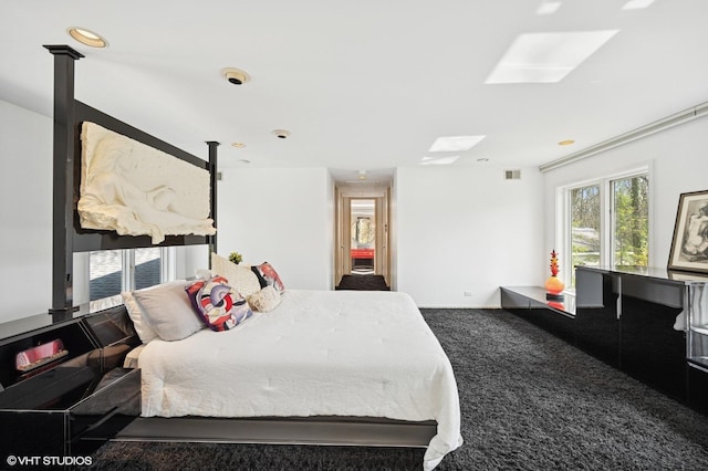 carpeted bedroom with recessed lighting and a skylight