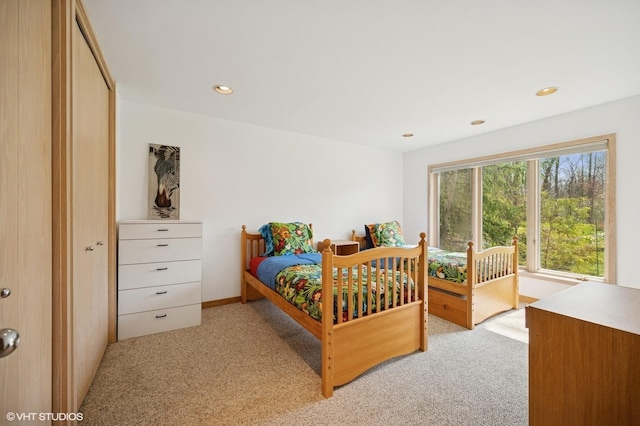 bedroom with access to outside, recessed lighting, and light carpet