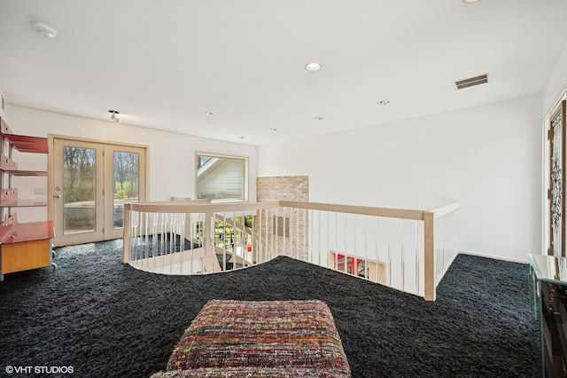 hall featuring french doors, an upstairs landing, carpet flooring, and visible vents