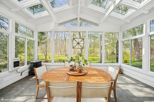 sunroom / solarium featuring a healthy amount of sunlight and lofted ceiling with skylight
