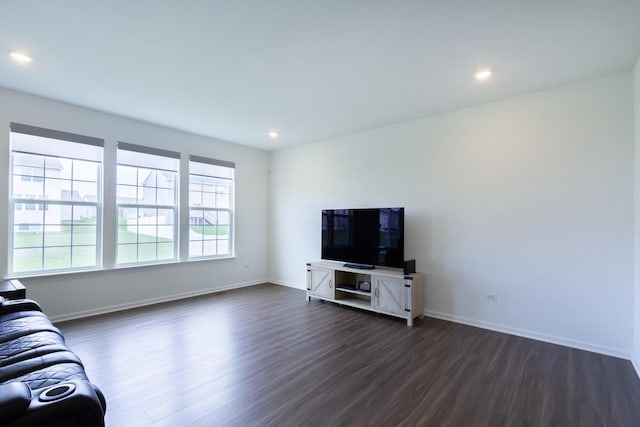 unfurnished living room with recessed lighting, baseboards, and dark wood-style floors