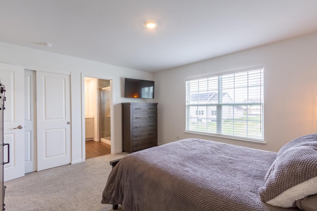 bedroom with carpet floors and ensuite bathroom