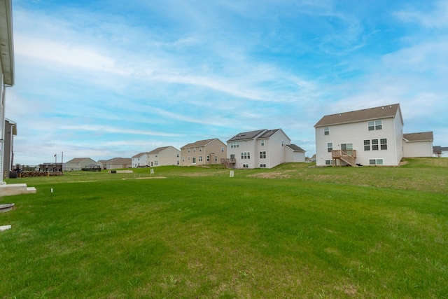 view of yard featuring stairs and a residential view