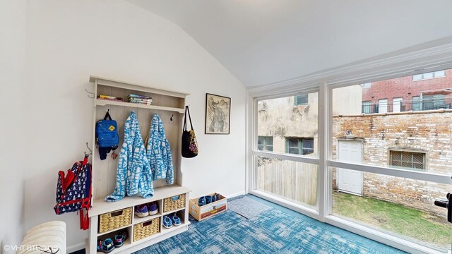 mudroom featuring lofted ceiling and baseboards