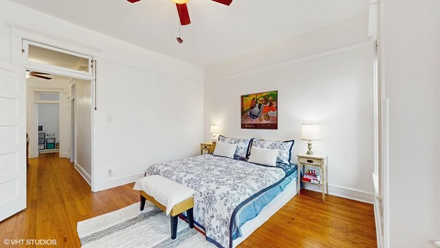 bedroom featuring wood finished floors, a ceiling fan, and baseboards