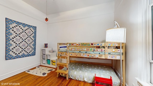 bedroom with wood finished floors and baseboards