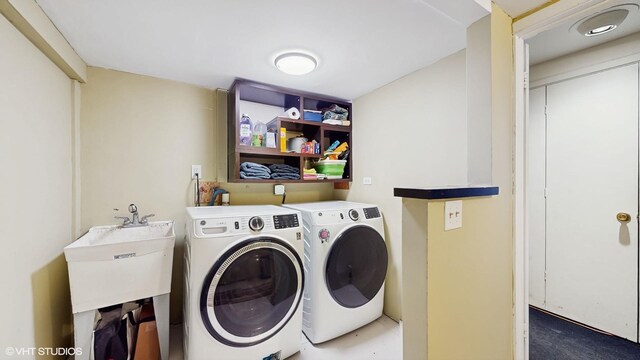 laundry room featuring washing machine and dryer, a sink, and laundry area