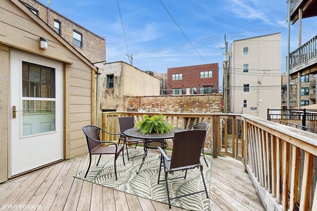 wooden deck featuring outdoor dining area