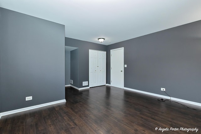 131 W Big Horn Dr Unit 131, Hainesville, IL 60030 - unfurnished room with visible vents, baseboards, and dark wood-style flooring