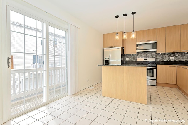 131 W Big Horn Dr Unit 131, Hainesville, IL 60030 - kitchen with dark countertops, light tile patterned floors, a kitchen island, decorative backsplash, and appliances with stainless steel finishes