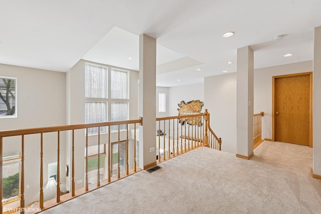 hall featuring carpet floors, recessed lighting, baseboards, an upstairs landing, and visible vents