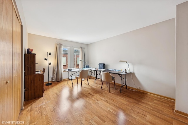 office with light wood-style floors and baseboards