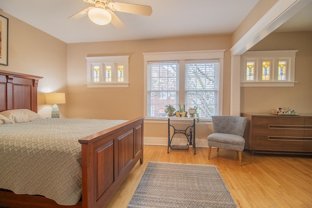 bedroom featuring baseboards, a ceiling fan, and light wood-type flooring