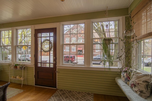 doorway with wood finished floors and plenty of natural light