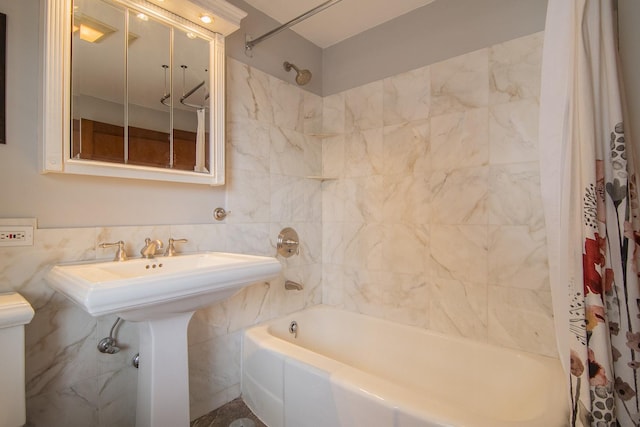 full bathroom featuring tile walls, shower / tub combo with curtain, and toilet
