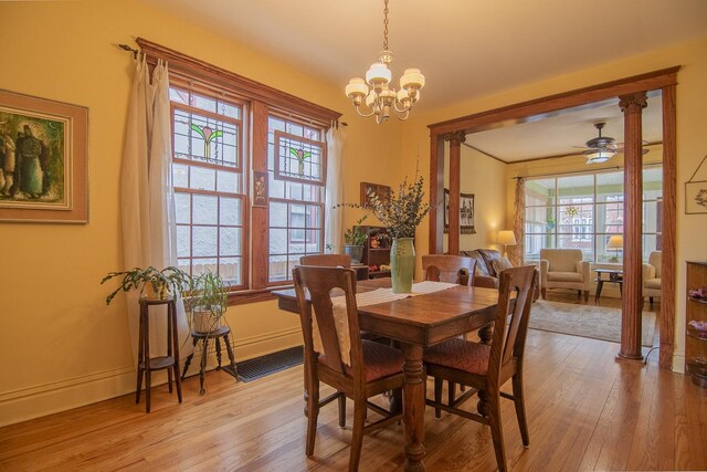 dining area featuring baseboards, ceiling fan with notable chandelier, and light wood-style flooring