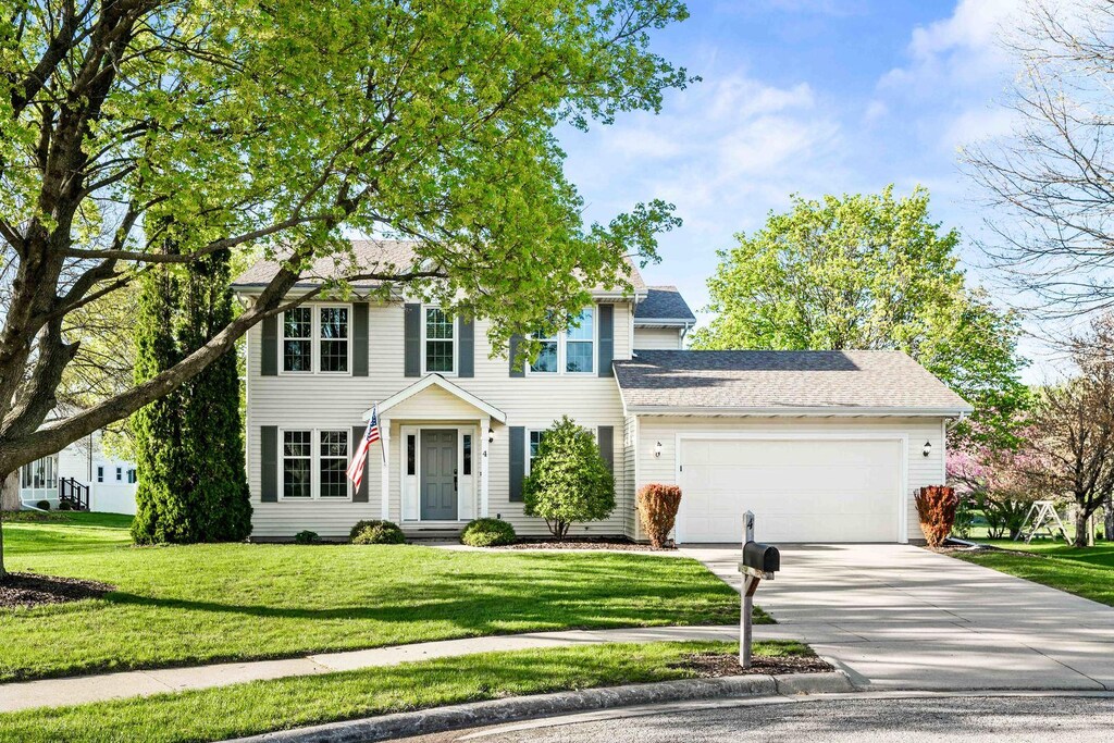 4 Tees Ct, Bloomington, IL 61704 - colonial home with an attached garage, a front yard, and concrete driveway