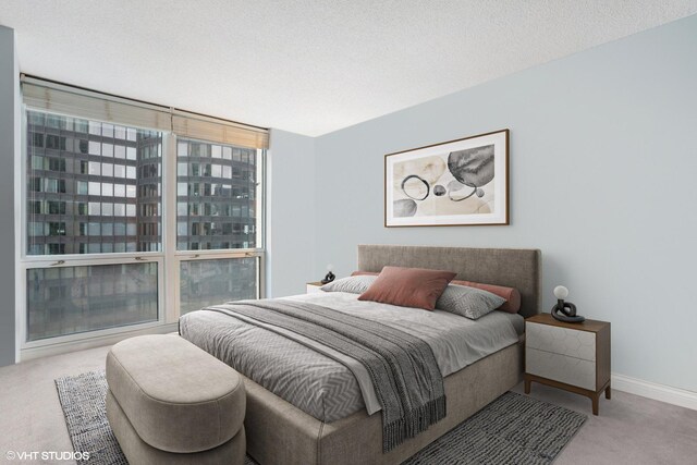 bedroom with baseboards and carpet