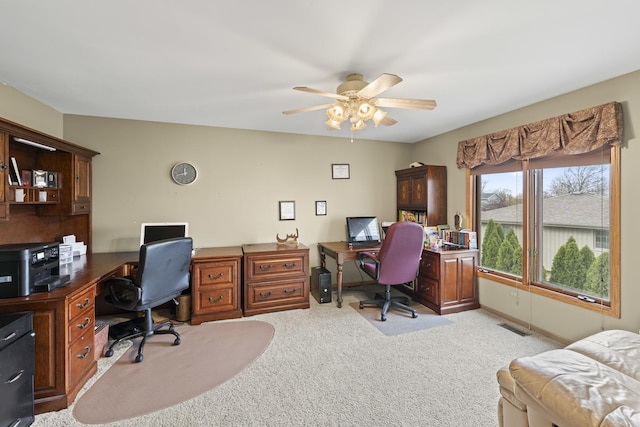 home office featuring ceiling fan, visible vents, and light colored carpet