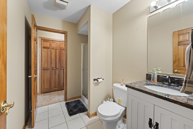 full bath with tile patterned floors, toilet, vanity, baseboards, and a stall shower