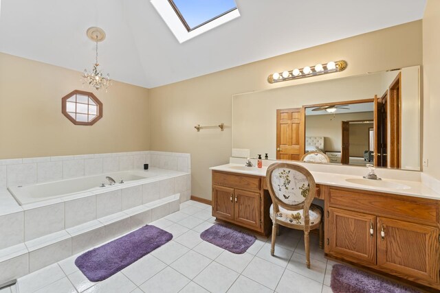 full bathroom with two vanities, a garden tub, a sink, and lofted ceiling with skylight
