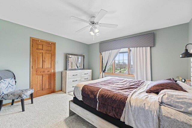 bedroom featuring light colored carpet and ceiling fan